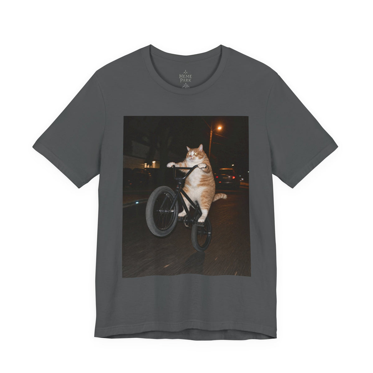Dark gray BMX Cat Tee, front view with an orange-and-white cat doing a bicycle wheelie at night.
