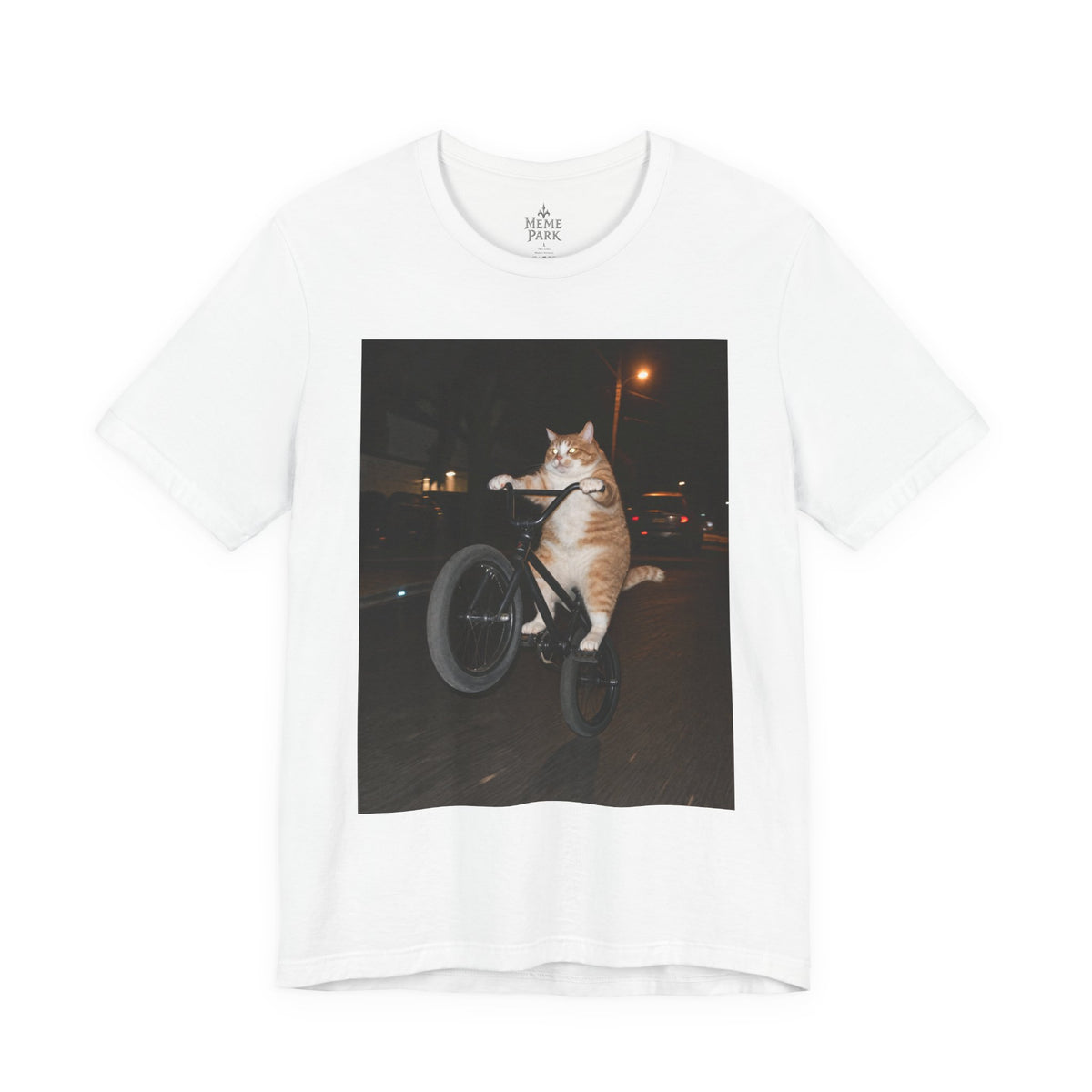 White BMX Cat Tee, front view with an orange-and-white cat doing a bicycle wheelie at night.